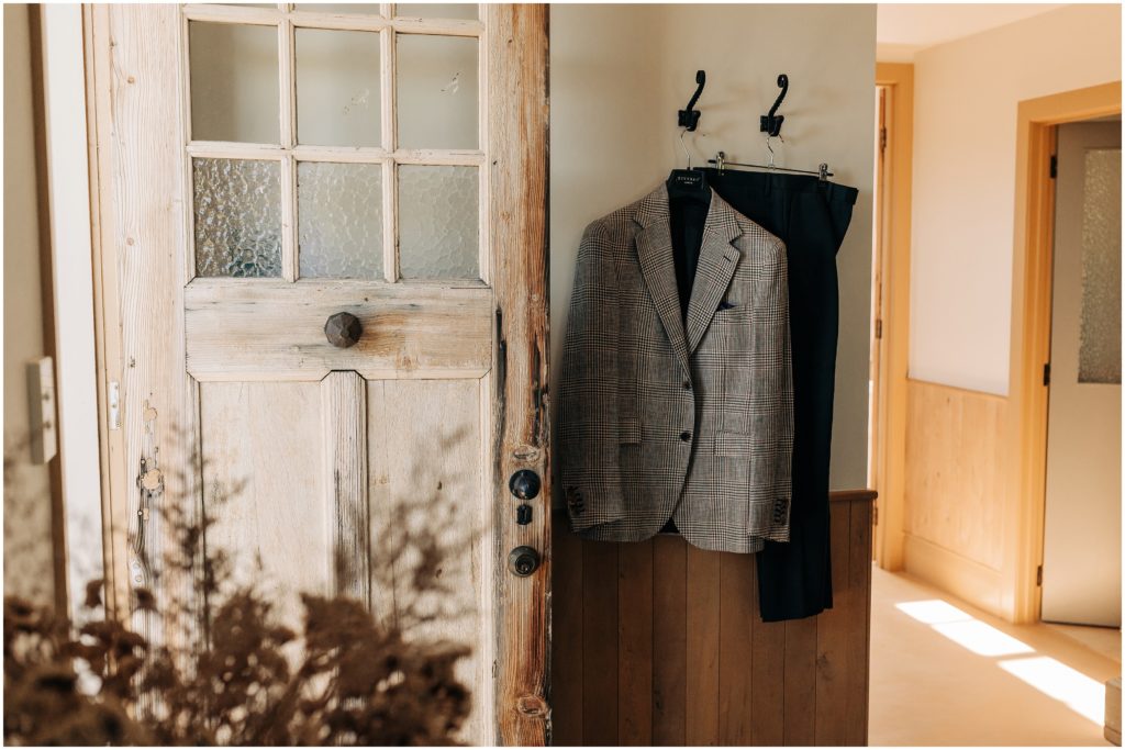 suit blazer diverso london hanging barn bell tower blenheim wedding photographer neutral colours sunny day