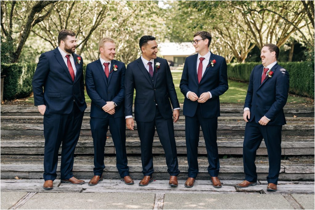 groom and groomsmen in navy suits with bouquets matching styles garden steps hideaway 201 winton invercargill wedding